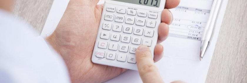 Businessman-Calculating-Invoice-At-Desk-000045326042_Large-890x500_c